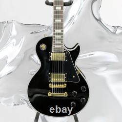 Guitare électrique noire LP avec des accessoires en or et un corps en acajou